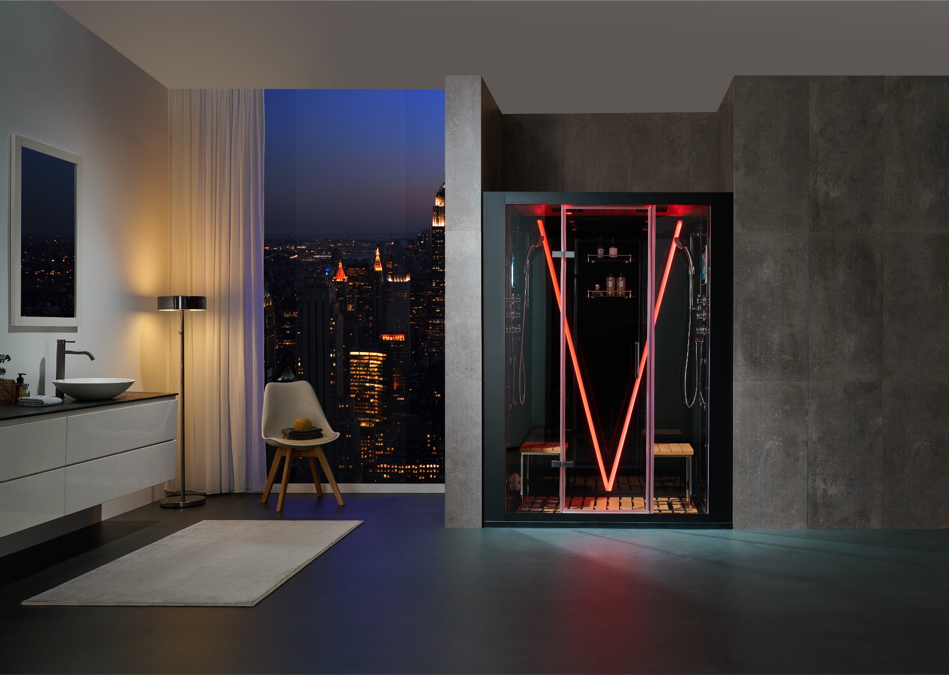 A modern glass steam room with red LED lighting stands in a luxury bathroom setting with a city skyline view at night.