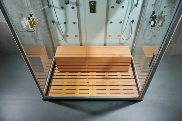 A glass steam room or sauna enclosure with a wooden bench and slatted wooden floor, shown from above on a gray floor.