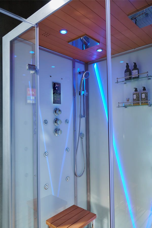 A modern glass shower cabin with a wooden seat, integrated ceiling rain shower, blue LED lighting, and shelves holding toiletry bottles.