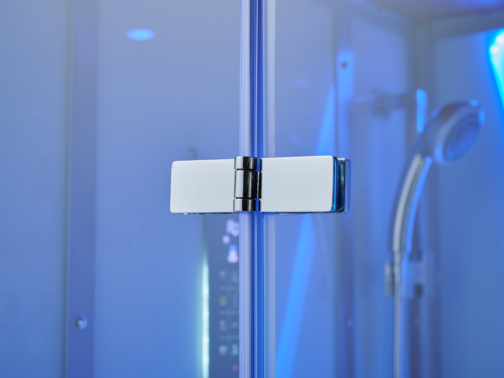 A close-up of a modern chrome shower glass door hinge, with a blurred blue-lit shower interior in the background.