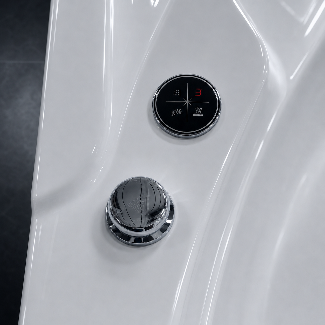 Close-up of a glossy white curved surface with two circular controls: a black round dial with white and red markings and a shiny chrome pop-up spout below.