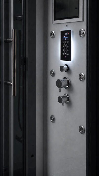 Close-up of a modern shower panel with a digital control screen, illuminated buttons, and multiple round chrome fixtures mounted on a light gray panel.